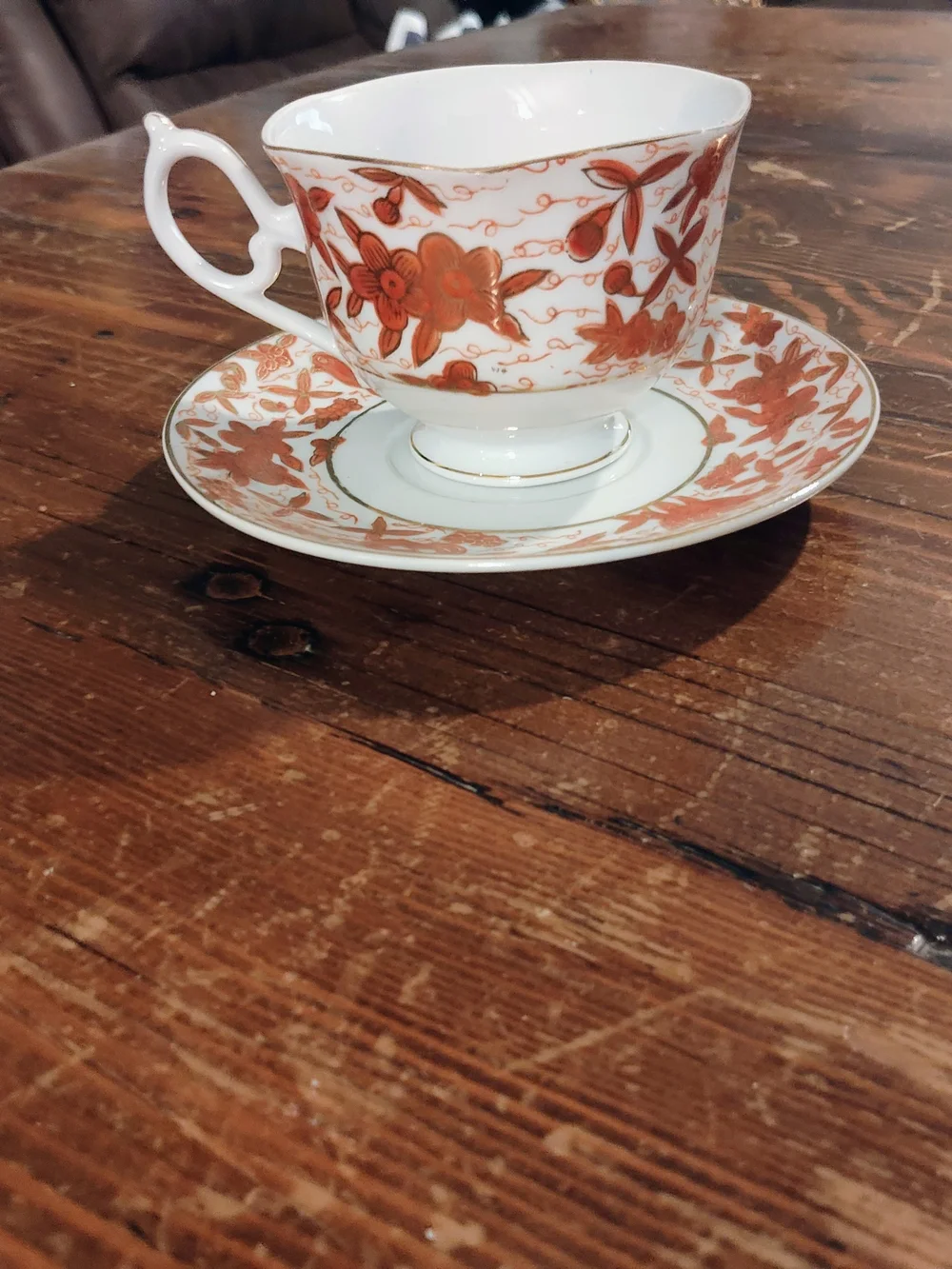 Porcelain Teacup and Saucer - White with Rust Floral Pattern